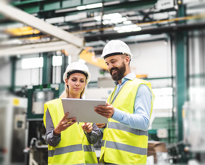 Man and woman with hardhat - Certifications and Audits for the Manufacturing Sector​